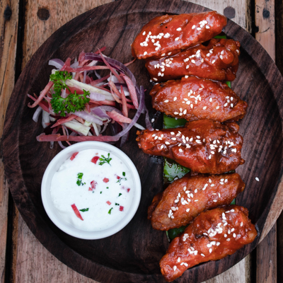 Sesame chicken wings with blue cheese on the side.